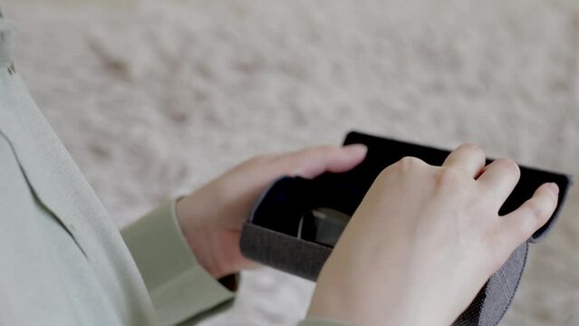 Female hands hold a case for glasses, open it and take out glasses for vision. close up