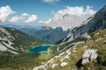 View from the Ehrwalder Alm to the famous Mountain Zugspitze with the lake Seebensee in the foreground.