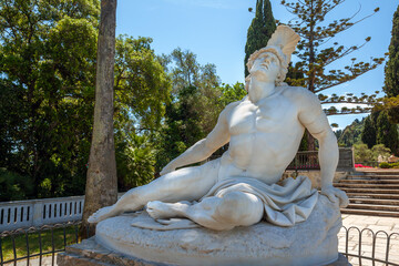 Obraz premium Dying Achilles, the famous statue at the gardens of the Achilleion Palace in Corfu, Greece, depicting the Greek hero scrambling and trying to remove the fatal arrow from his heel. 