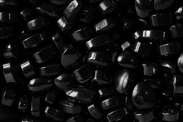 Small polished black stones macro closeup