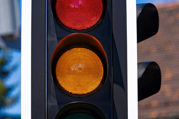 Traffic light with red led light and orange light at Swiss City of Zürich on a sunny spring day....