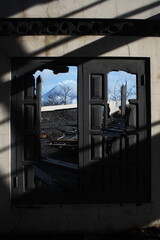 Thick shadow lines on the walls of houses with windows that have been destroyed by the violent eruption of Mount Merapi.