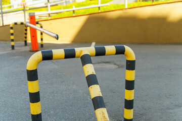 Barrier gate and metal vehicle bollards controlling access
