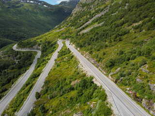 Fototapeta premium Borlaug, Norway. Cars Goes On Serpentine Mountain Road . Famous Norwegian Landmark And Popular Destination. Norwegian Hemsedalsvegen road In Summer Day.