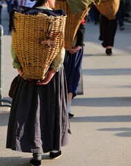 Women with baskets during the historical reenactment of the CARNICHE CARRIERS group who made their...
