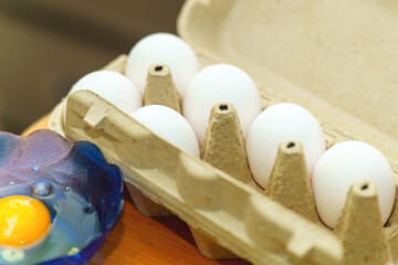 Chicken eggs nestled in a gray cardboard carton