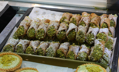 Sicilian Cannoli Filled with Ricotta and chopped pistachios. on Sale in Sicily Italy