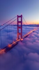 Fototapeta premium Golden Gate Bridge shrouded in dawn fog, seen from high point, distant city lights twinkle
