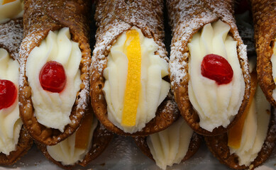 Sicilian cannoli filled with ricotta and with cherry and orange for sale in Sicily Southern Italy