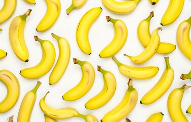 Bright yellow scattered bananas on a white background. Top View