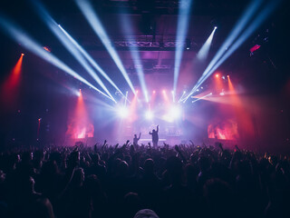 Concert stage lighting creates a dynamic backdrop, blurring into a live disco party scene