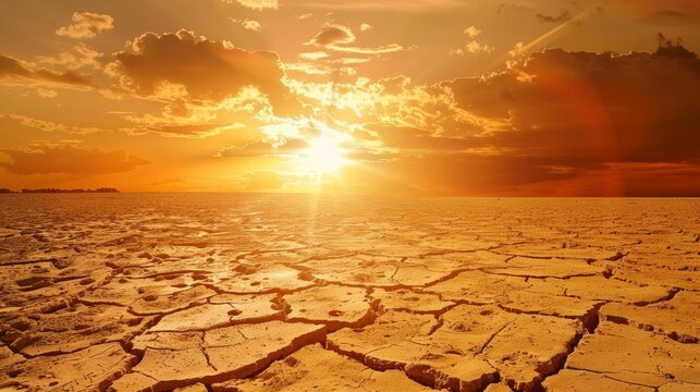 A desolate desert landscape with a sun setting in the background
