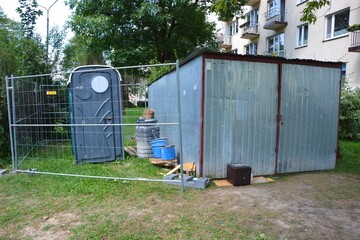 Naklejka premium Tin garage for construction tools during renovation of the block