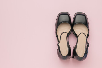 Pair of Elegant Black High Heels against Soft Pink Background
