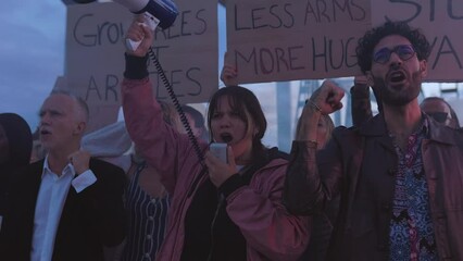 Diverse group of activists people holding posters and banners antiwar protesting against war and violence in the world.