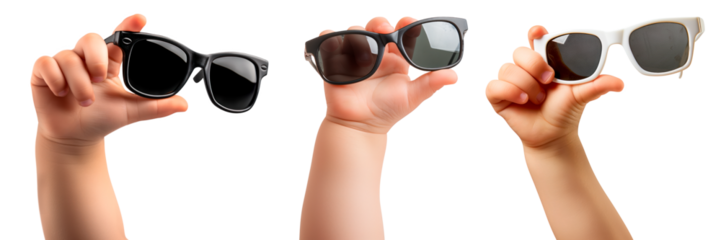 A set of children's hands holding sunglasses isolated on a white or transparent background. Close-up of black and white glasses in hands. Rest, holidays, sun protection. Vacation and travel concept.
