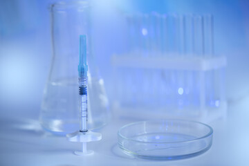 Injection syringe in the background of the chemical laboratory, scientific laboratory research and development of injections of beauty.