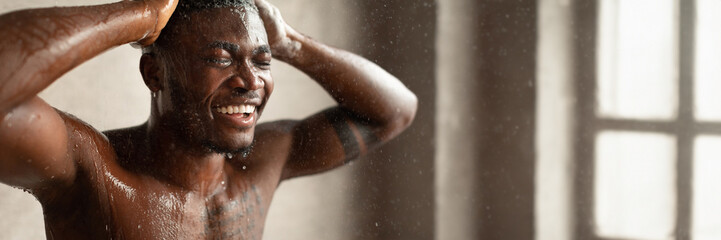 Black Man Taking Shower And Washing Head Standing With Eyes Closed Relaxing Under Hot Water In...