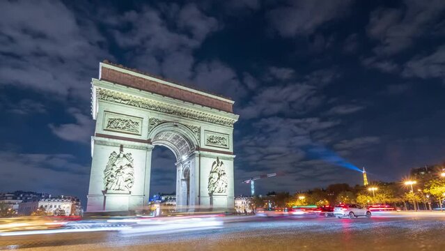 4K Timelapse of traffic at Arc de Triomph at night. This historical monument overlooks the avenue des champs &eacute;lys&eacute;es in the heart of Paris, French capital.
