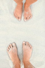 beautiful legs on sand near the sea shore on nature background