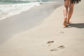 beautiful traces with feet near the sea on nature background