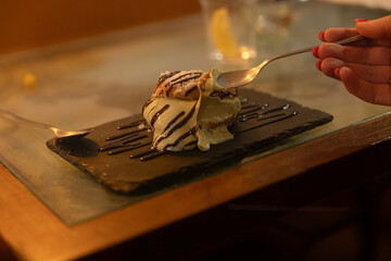 creamy pistachio cake on the plate in the restaurant 