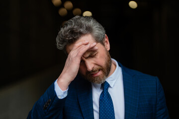 Sad business man got migraine. Man with strong headache. Stressed, tired businessman from headache. Headache, tiredness and stress, migraine. Headache pain concept.