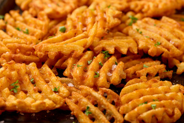 Crisscross potato lattices, golden waffle fries with sea salt and parsley
