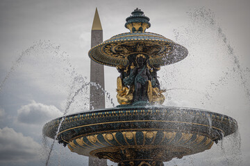 fountain in Paris with luxor obelisks in the background 