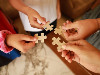 A woman hands connecting jigsaw puzzle , success and strategy concept.