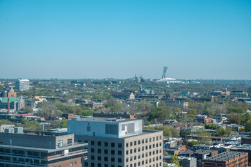 Naklejka premium High panoramic view of Olympic Stadium, at Olympic Park in the Hochelaga-Maisonneuve district of the city, the world's tallest inclined tower, Angus neighbourhood, Quebec, Canada (May 2024).