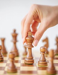 The person making the move in a chess match moves the piece with her hand
