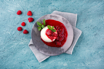 Traditional quark mousse with rhubarb and raspberry compote served as top view on a Nordic Design plate