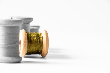 Spools of thread black and white and one spool of green thread colored, threads and sewing, style