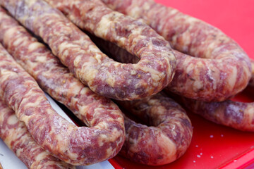 Freshly Prepared Sausages on a Bright Red Background During Daytime