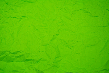 Green background with dense wrinkles. Green recycled kraft paper texture as background.