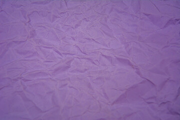 Purple background with dense wrinkles. Purple recycled kraft paper texture as background.
