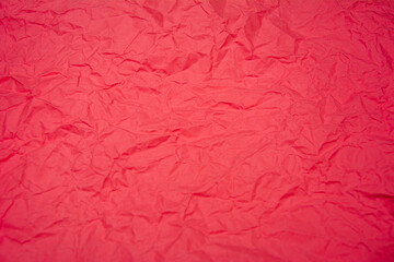 Red background with dense wrinkles. Red recycled kraft paper texture as background.