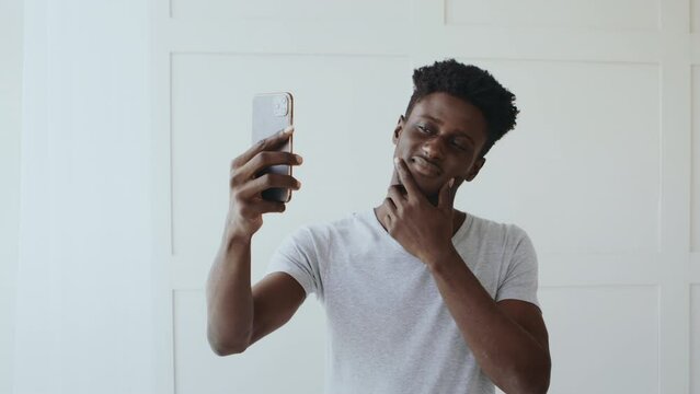 leisure. Handsome african man making selfie, admiring himself in cellphone