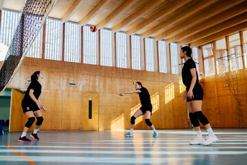 Low angle shot of a diverse female pro volleyball players in action at the net
