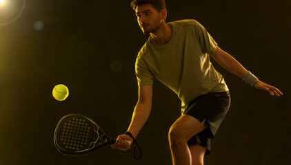 Padel Tennis Player with Racket in Hand. Paddle tenis, on a black background. Download in high...