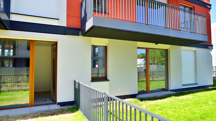 The garden of a modern residential building with a green lawn and a place to relax.