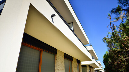 Fototapeta premium Eco-friendly living in city with greens. Eco apartment building saving energy and fresh air concept. 