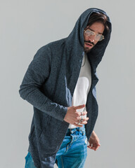 attractive young guy with glasses and hoodie posing in a cool way