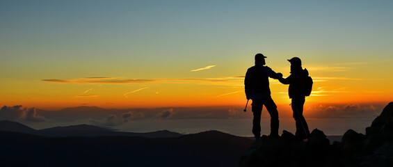 People Welcoming the Sunrise at the Summit