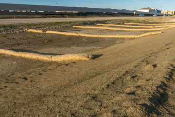Biodegradable erosion control straw sock guard fixed on road ditch slope to protect from water runoff erosion