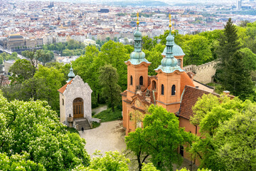 Church of St. Lawrence on Petrin hill above the capital Prague. City center panorama.