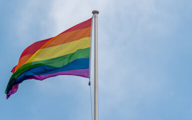 flag of rainbow,Rainbow flags, Flag for LGBT, LGBTQ or LGBTQIA+ Pride, The rainbow LGBTQ flags flies in the blue sky