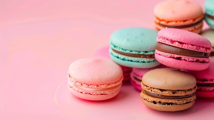 Fototapeta premium A pile of colorful macarons on a pink background.