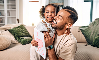  Daughter congratulates dad on Father's Day. A gift and card for a dad who hugs a child.